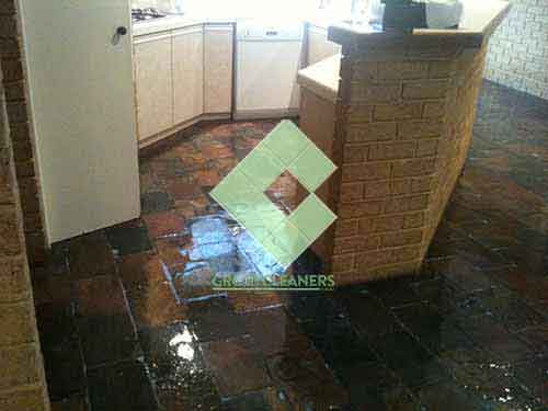 slate_tiles_in_kitchen_floor_after_sealing_with_shiny_topical_sealer